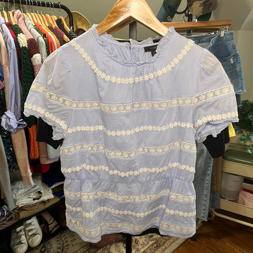 J. Crew blue short-sleeved blouse with floral embroidering.